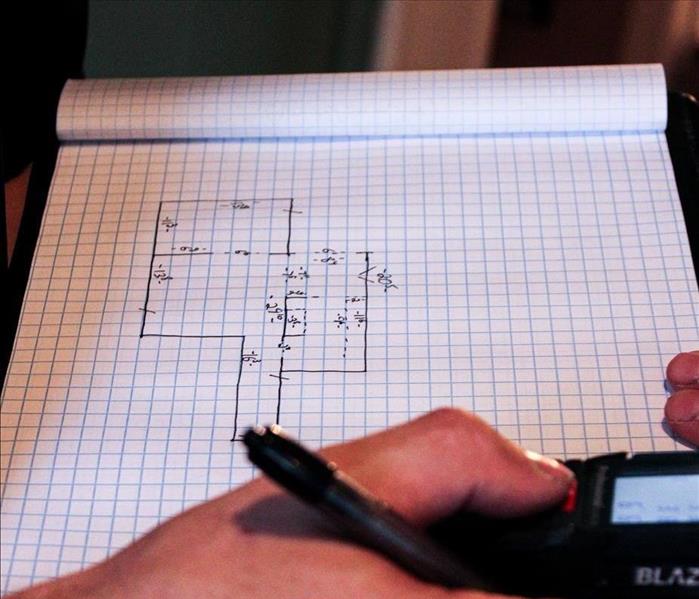 SERVPRO of Alexandria's crew chief making a floor plan sketch of the affected property