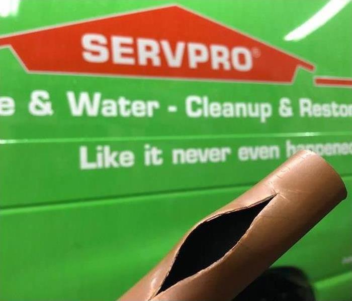 water damaged pipe burst in front of a SERVPRO van